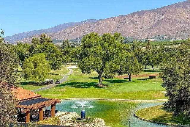 a view of a swimming pool with a yard and mountain view