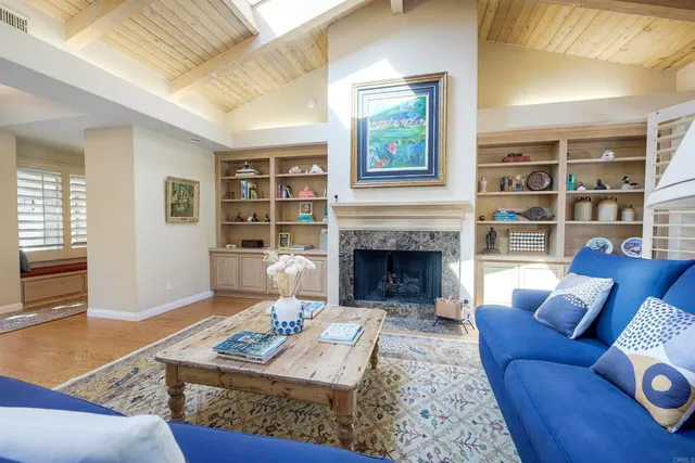 a living room with furniture potted plant and a large window
