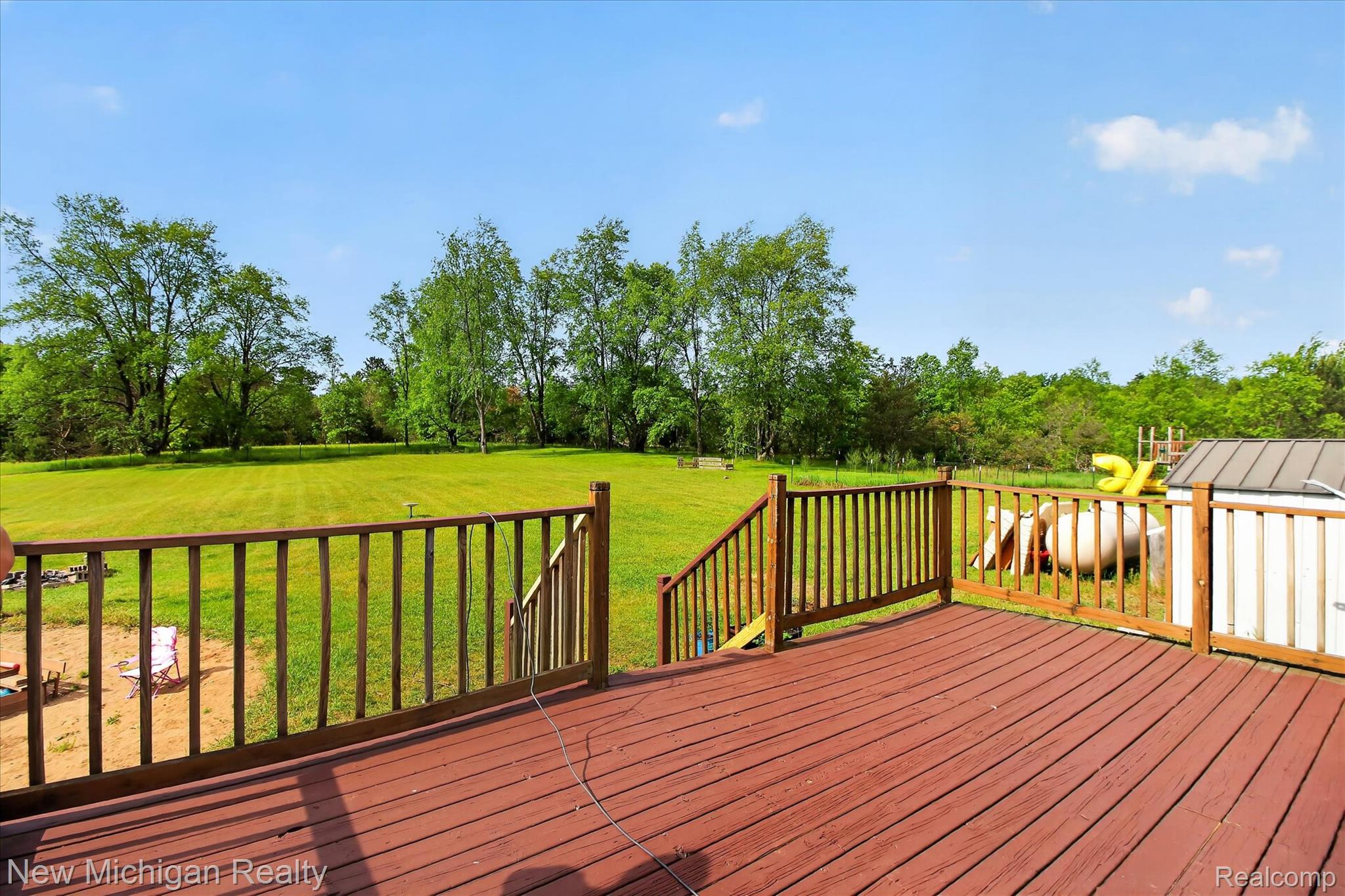 22623 11 Mile Road Reed City, MI 49677 - Photo 38 of 47 Spacious wood deck with a rich red-brown finish