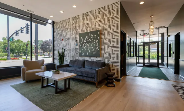 a living room with furniture and a floor to ceiling window