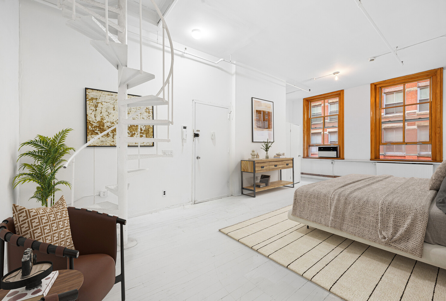 108 Wooster Street, Unit 3A Manhattan, NY 10012 - Photo 6 of 10 a spacious bedroom with a bed and a couch