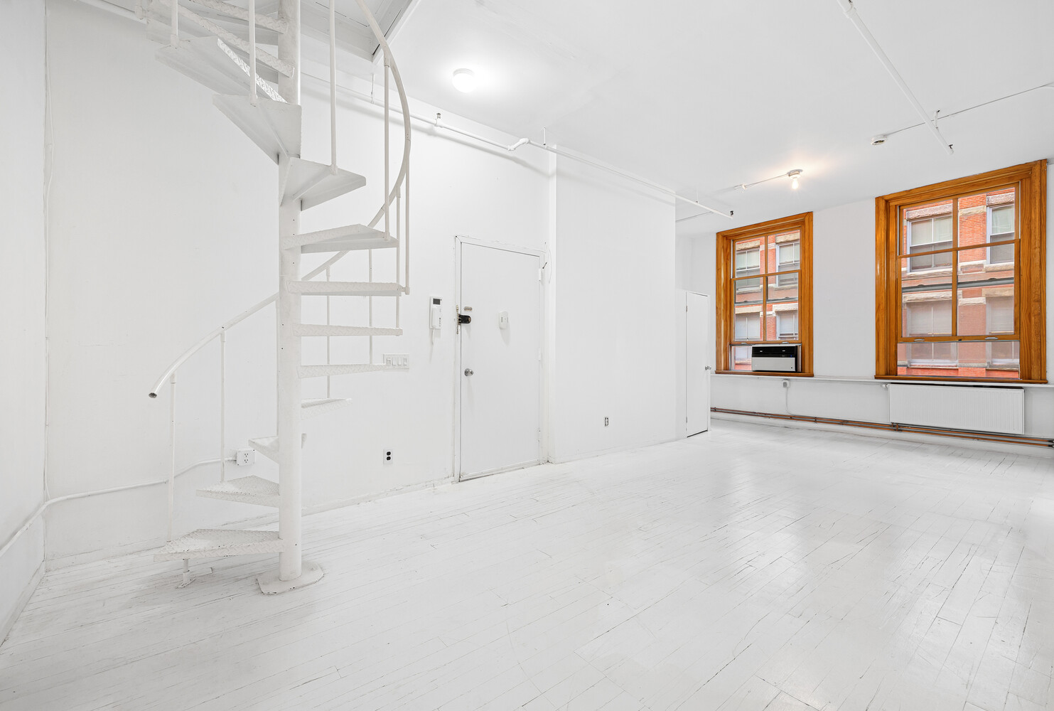 108 Wooster Street, Unit 3A Manhattan, NY 10012 - Photo 7 of 10 a view of an empty room with a window