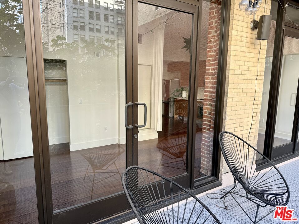 460 South Spring Street, Unit 205 Los Angeles, CA 90013 - Photo 11 of 18 a view of a hallway with wooden floor and staircase