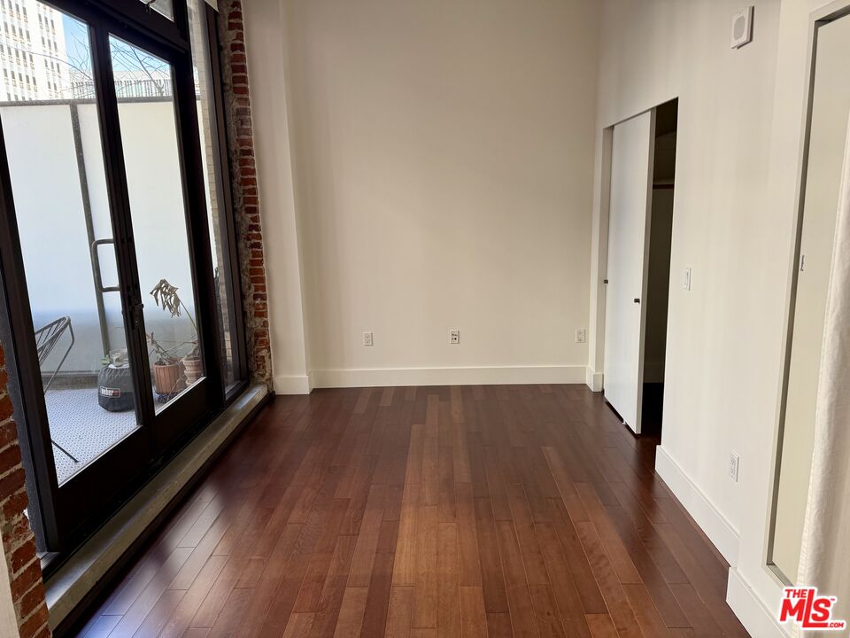 460 South Spring Street, Unit 205 Los Angeles, CA 90013 - Photo 16 of 18 a view of a room with wooden floor and fireplace