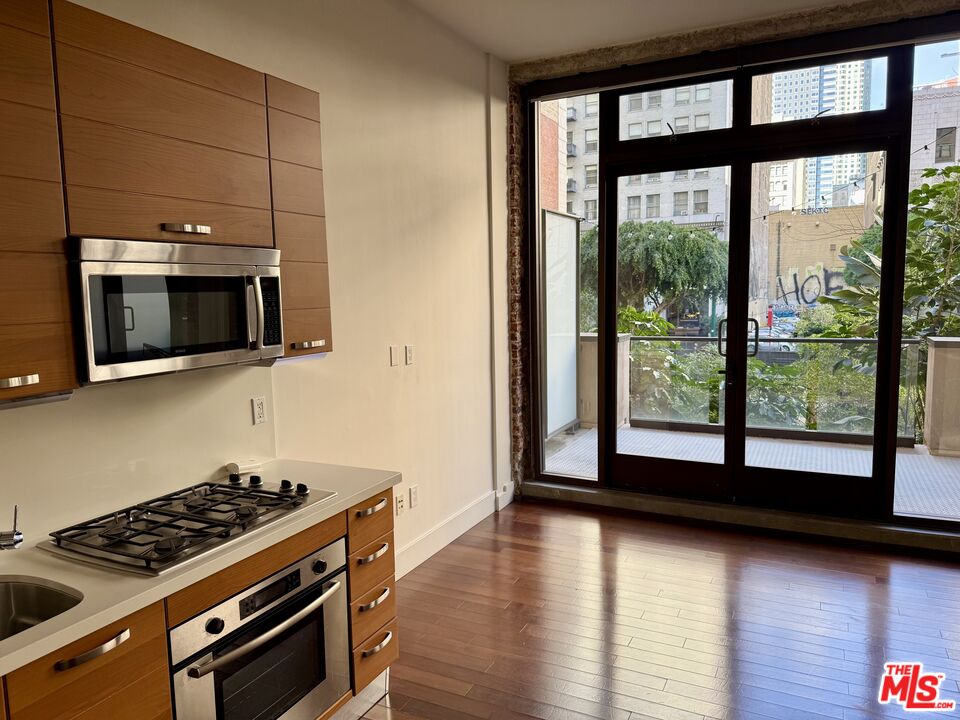 460 South Spring Street, Unit 205 Los Angeles, CA 90013 - Photo 18 of 18 a kitchen with a stove and a microwave