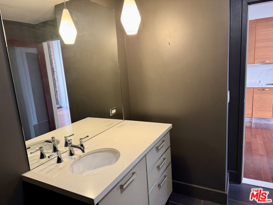 460 South Spring Street, Unit 205 Los Angeles, CA 90013 - Photo 5 of 18 a bathroom with a sink vanity and a mirror