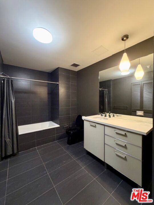 460 South Spring Street, Unit 205 Los Angeles, CA 90013 - Photo 6 of 10 a bathroom with a mirror and a shower