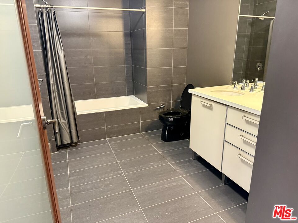 460 South Spring Street, Unit 205 Los Angeles, CA 90013 - Photo 8 of 18 a bathroom with a sink a toilet and a shower