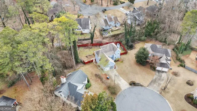 an aerial view of a house with a yard and fountain