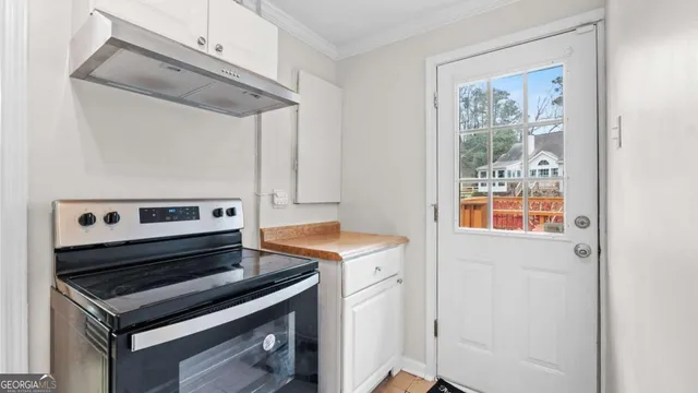 a kitchen with a stove and a microwave
