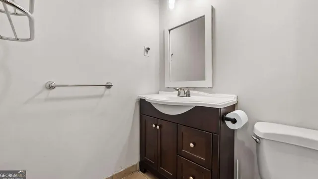 a bathroom with a sink vanity and a toilet
