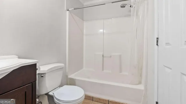 a white toilet sitting next to a bath tub