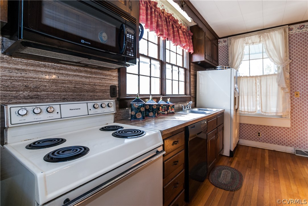 11513 Beach Road Chesterfield, VA 23838 - Photo 13 of 29 a kitchen with appliances cabinets and a wooden floor