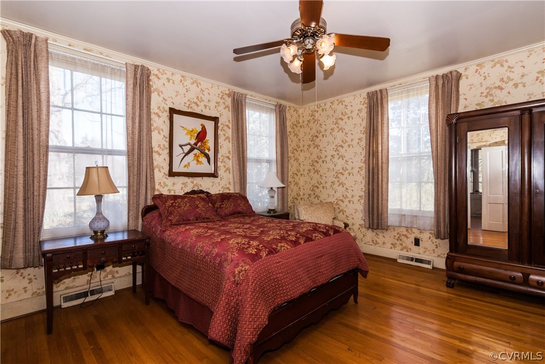 11513 Beach Road Chesterfield, VA 23838 - Photo 17 of 29 a bedroom with a bed and a chandelier