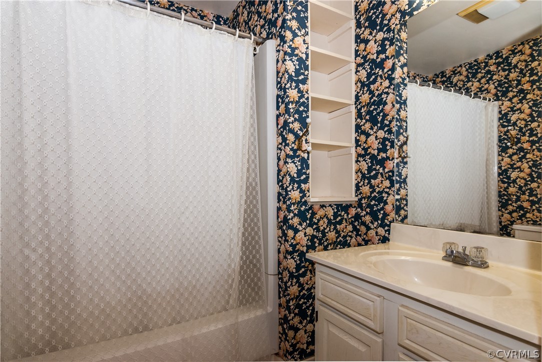 11513 Beach Road Chesterfield, VA 23838 - Photo 21 of 29 a bathroom with a sink and a shower curtain