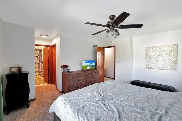 a bedroom with a bed and a dresser