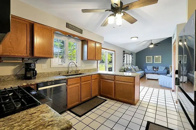 a kitchen with stainless steel appliances granite countertop a sink and cabinets
