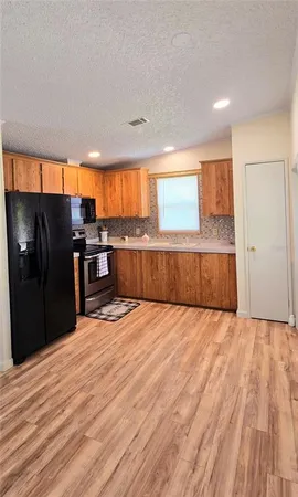a view of kitchen with wooden floor