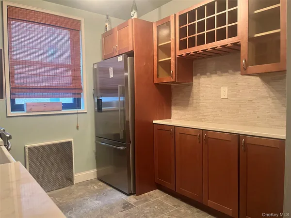 a kitchen with a refrigerator and cabinets