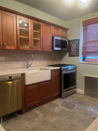 a kitchen with stainless steel appliances granite countertop a sink stove and cabinets