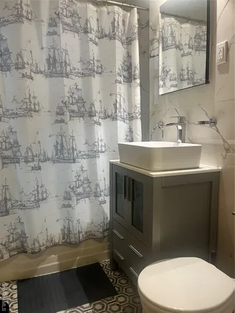 a bathroom with a sink toilet and shower