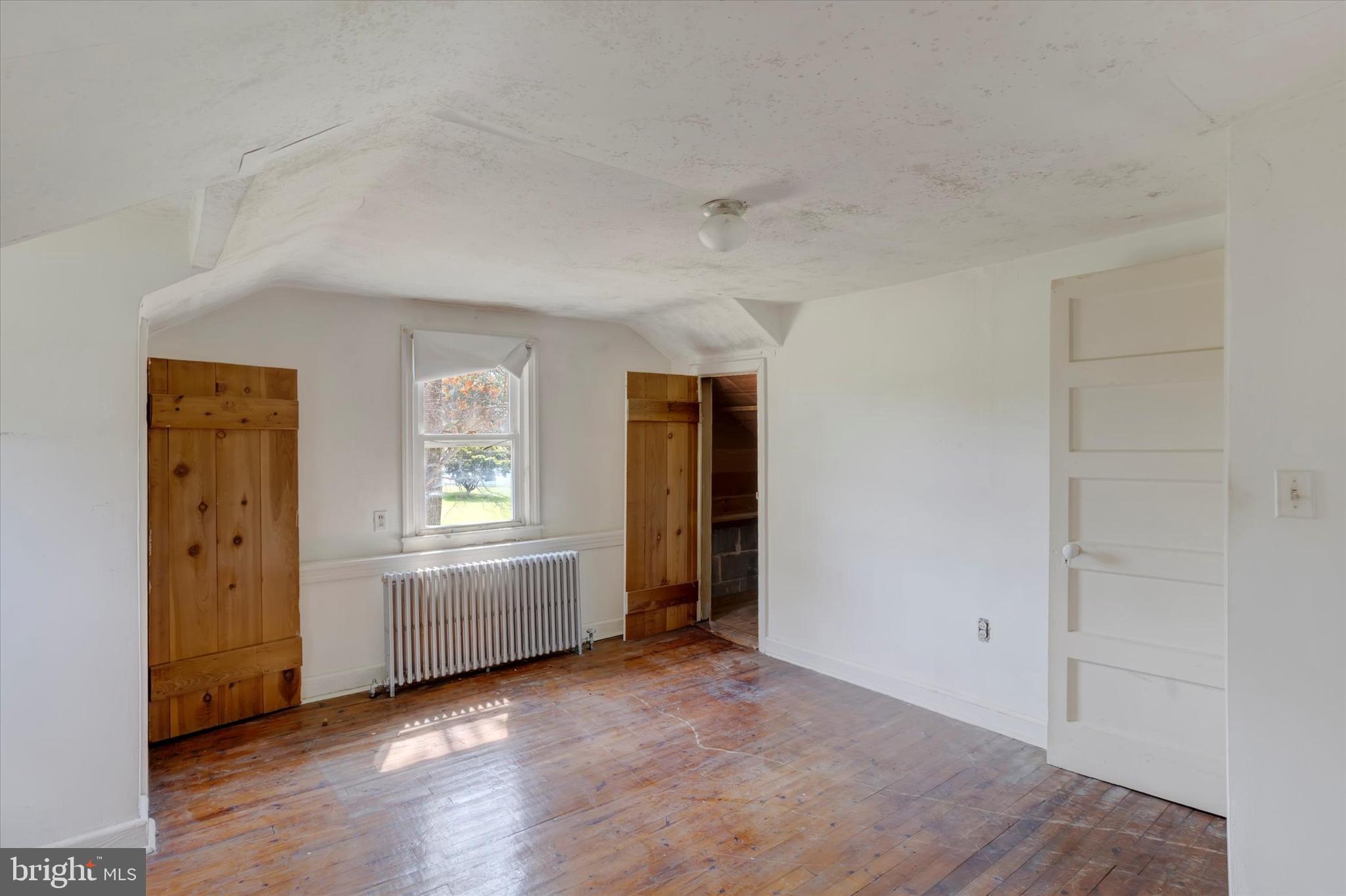 15526 Holly Grove Road Silver Spring, MD 20905 - Photo 11 of 19 an empty room with windows and cabinet