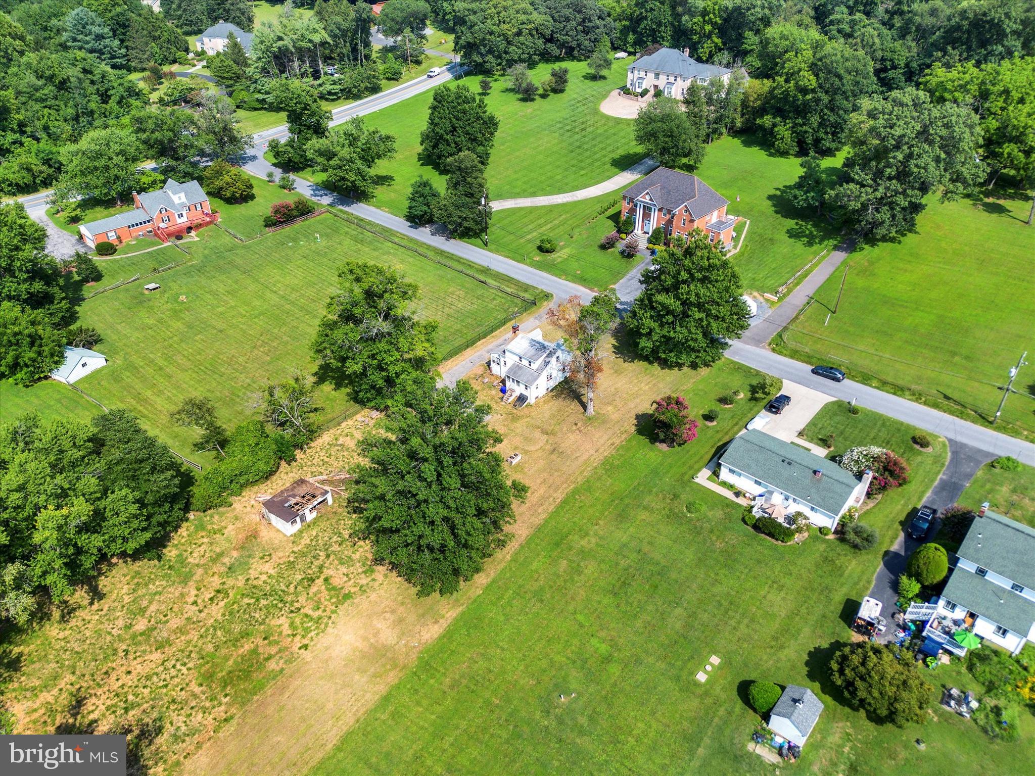 15526 Holly Grove Road Silver Spring, MD 20905 - Photo 17 of 19 an aerial view of a house with a yard and lake view in back