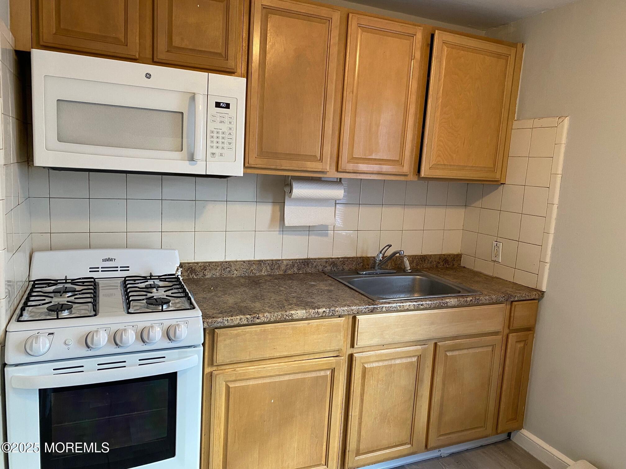 20 Oldfield Place Red Bank, NJ 07701 - Photo 1 of 11 a kitchen with granite countertop a stove sink and cabinets