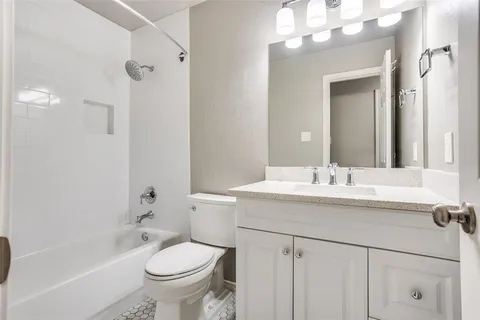 a bathroom with a sink and mirror with toilet
