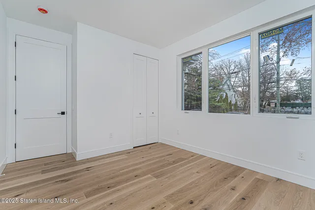 a view of wooden floor and windows in a room