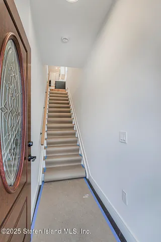 a view of entryway with furniture and stairs
