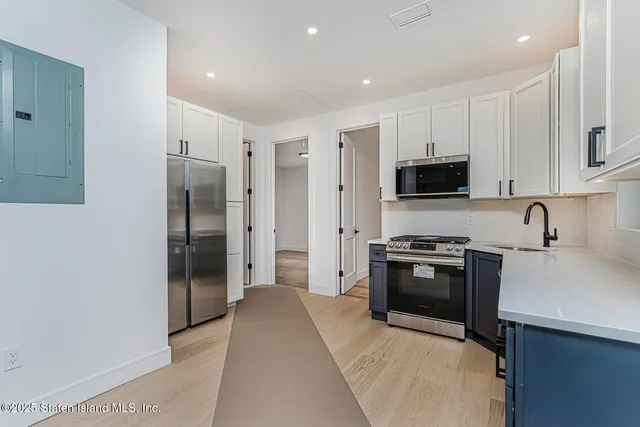 a kitchen with stainless steel appliances a refrigerator stove and sink
