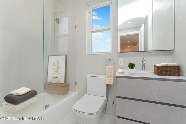 a bathroom with a toilet a sink and mirror