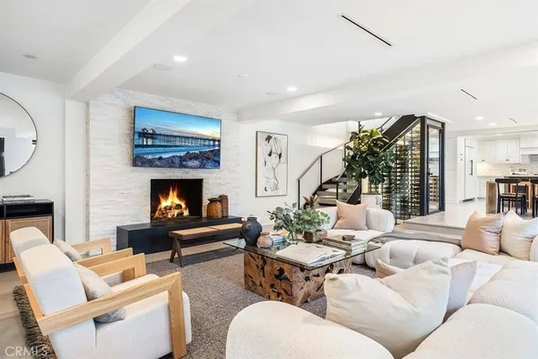 a living room with furniture fireplace and a large window