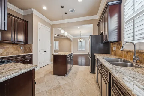 a kitchen with a sink stove and refrigerator