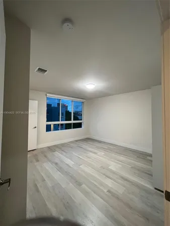 a view of a hallway with washer and dryer