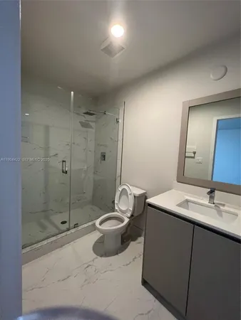 an empty room with wooden floor and closet