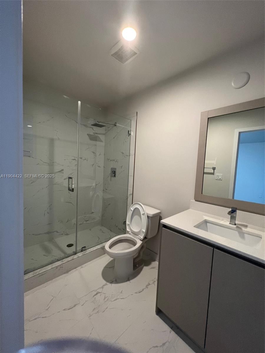 2561 Northeast 193rd Street, Unit 1206 Miami, FL 33180 - Photo 14 of 16 a bathroom with a sink toilet and shower