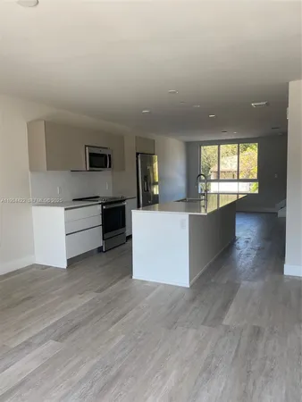 a view of a kitchen with microwave and cabinets