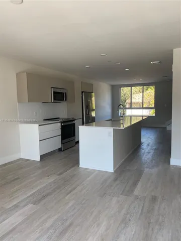 a view of a kitchen with microwave and cabinets