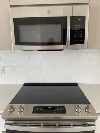 a stove top oven sitting inside of a kitchen