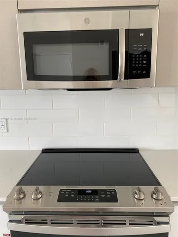 a stove top oven sitting inside of a kitchen