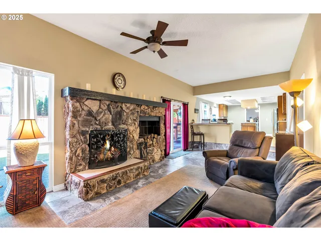 a living room with furniture a rug and a floor to ceiling window