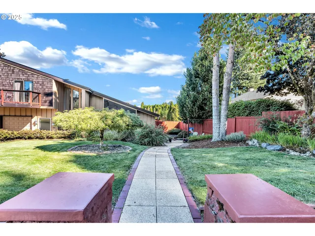 a view of yard with swimming pool and green space