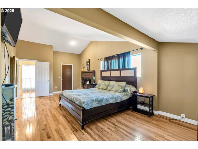 a living room with a bed furniture and a flat screen tv