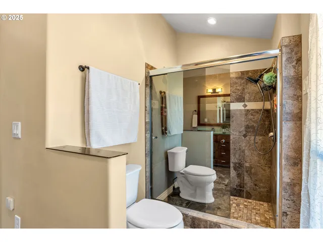 a bathroom with a toilet and a shower