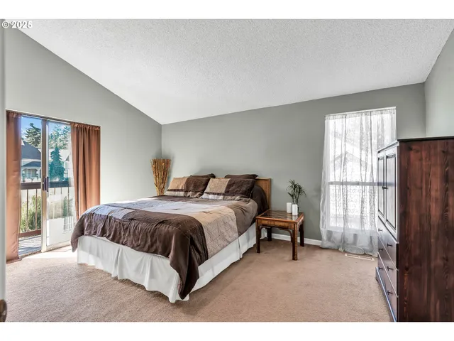 a spacious bedroom with a bed and a window