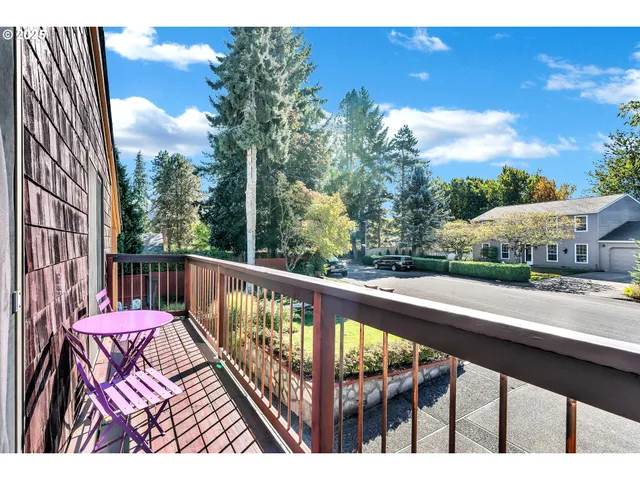 a view of balcony with wooden floor and fence