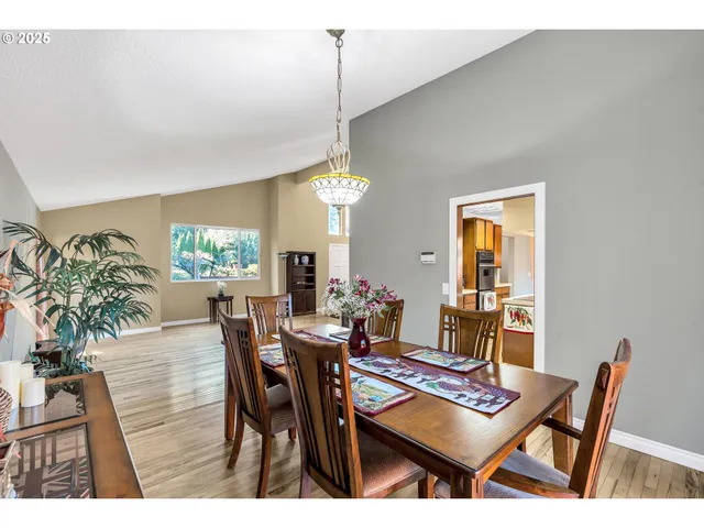 a dining room with furniture a rug and a chandelier