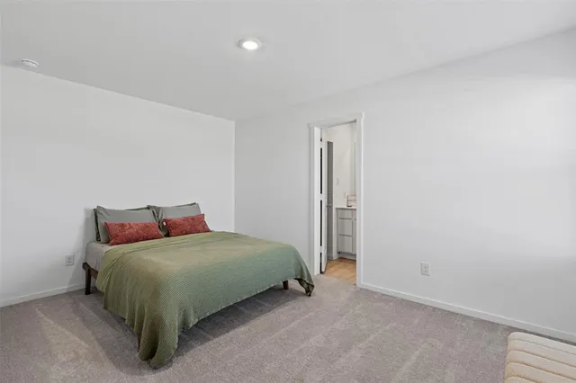 a bedroom with a bed and a night stand